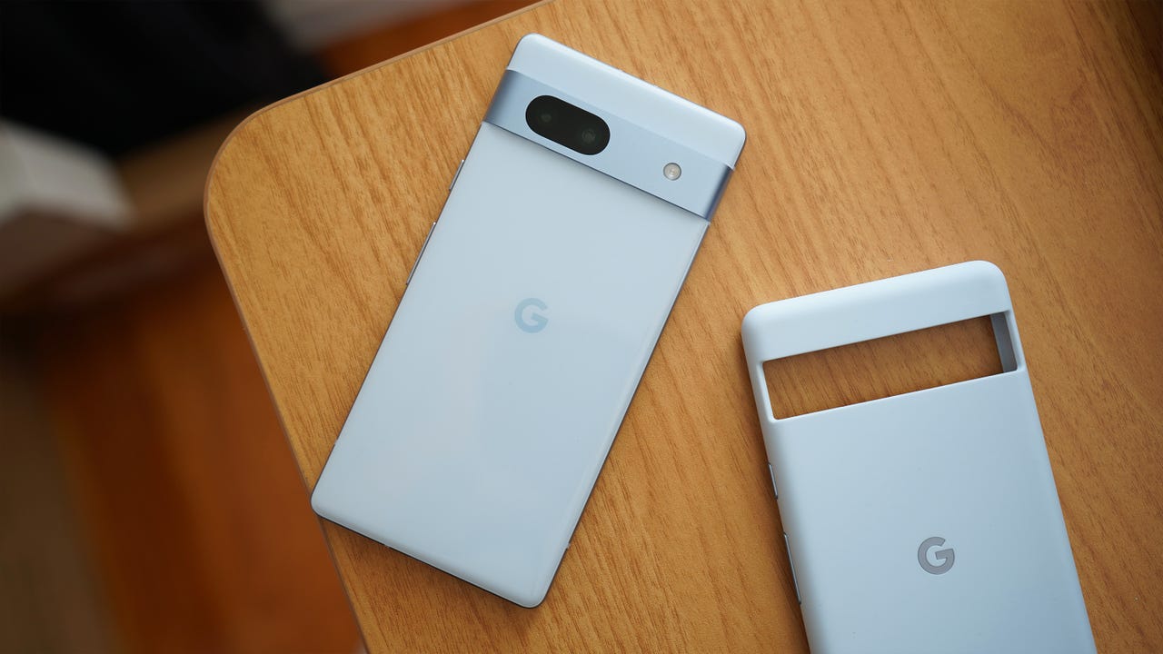 The backside of the Google Pixel 7a next to a silicone cover.