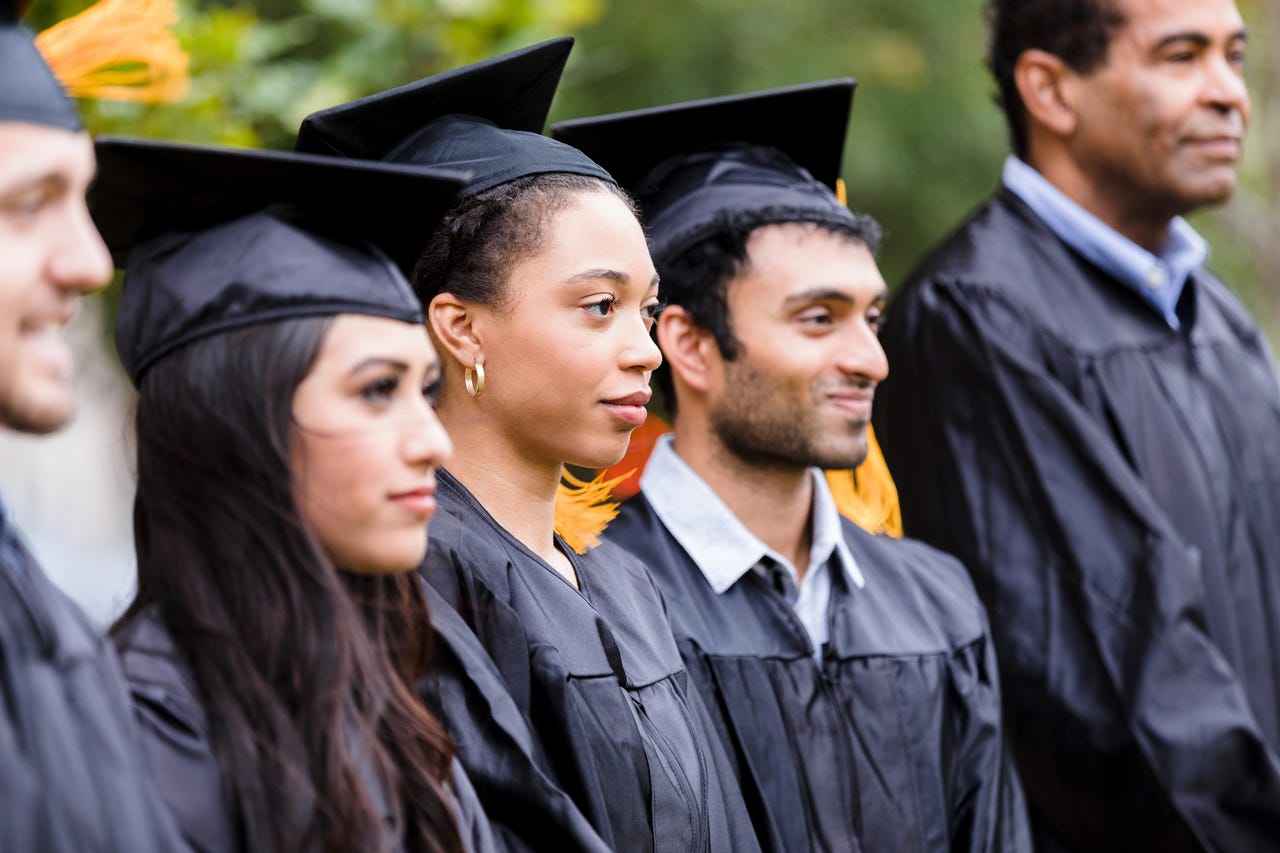 diverse-graduates-stand-in-row-before-ceremonygettyimages-1366624326