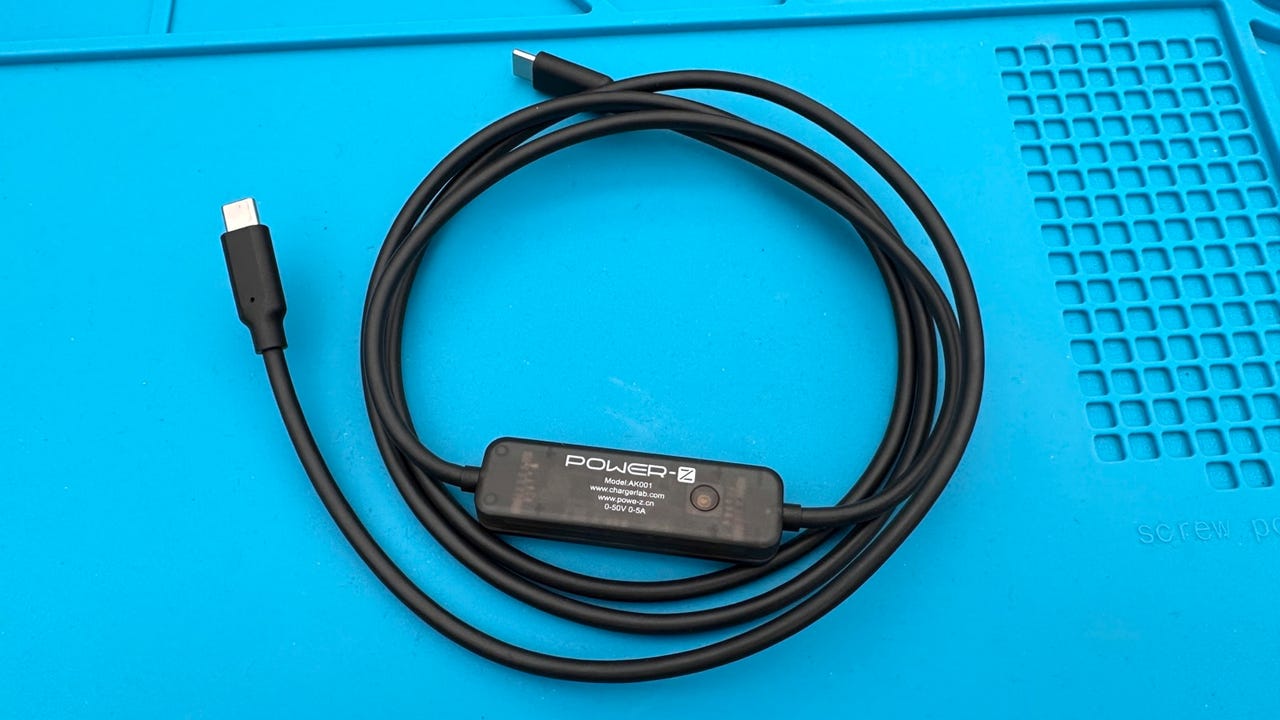 ChargerLAB Power-Z AK001 USB-C cable with power meter on a blue background