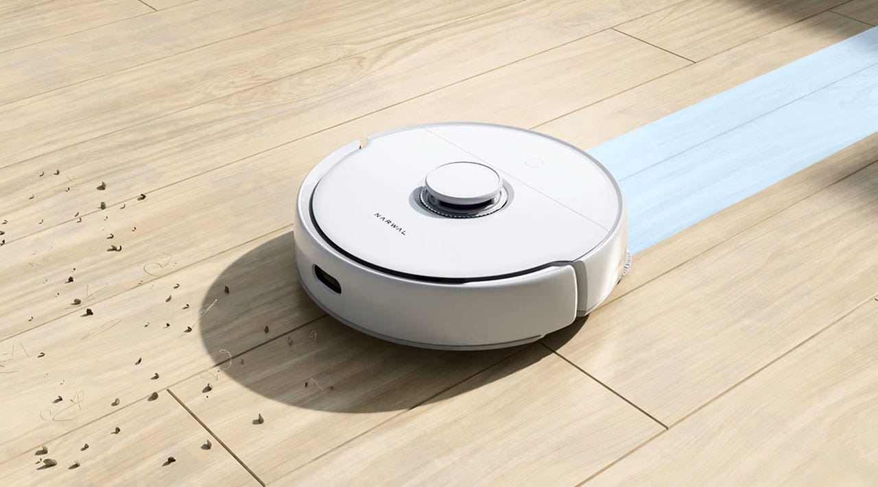 Narwal Freo robot vacuum on floor cleaning dirt and dust