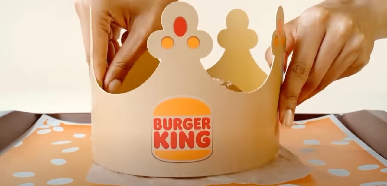Someone holding a Burger King crown.