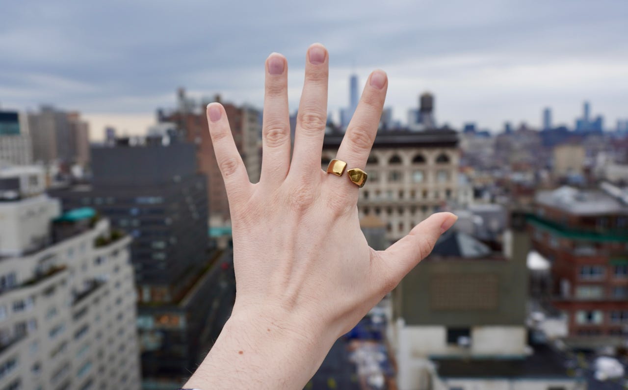 Evie ring on hand in cityscape