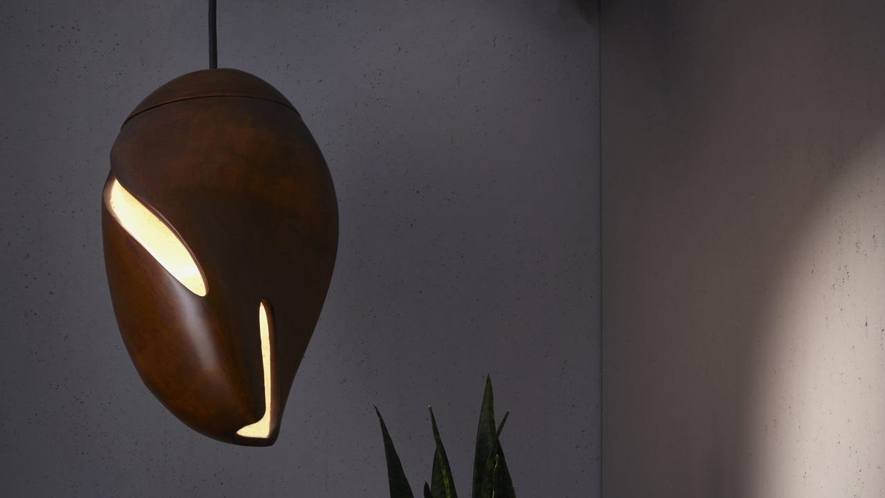 A lit wooden lamp hanging from the ceiling