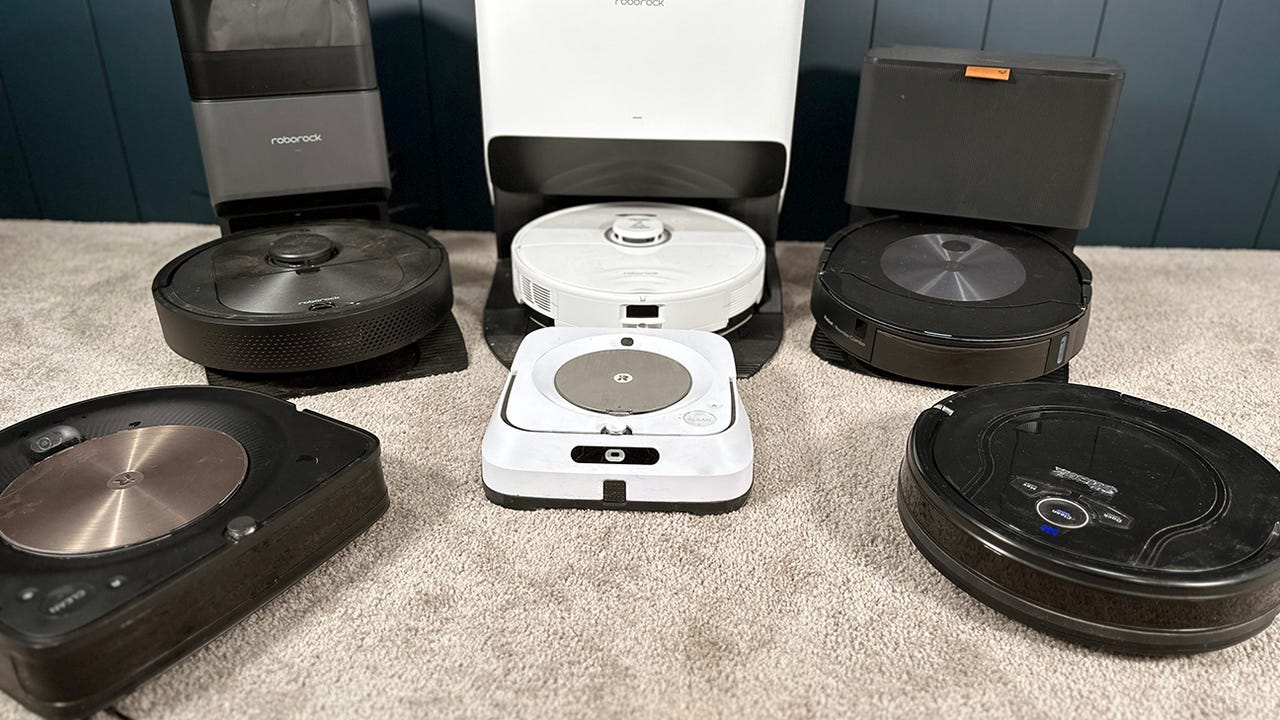 Several robot vacuum cleaners are sitting together.