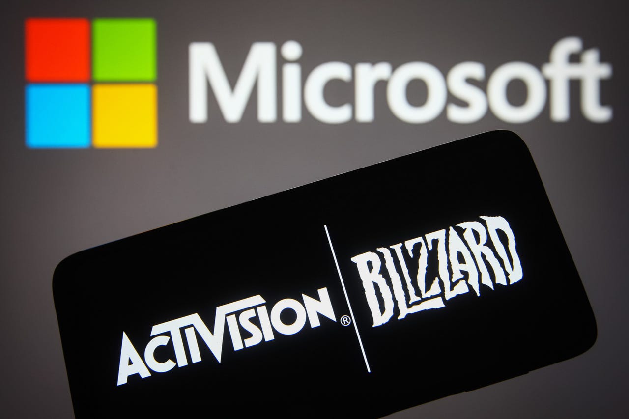 Activision Blizzard logo on a phone in front of a Microsoft background