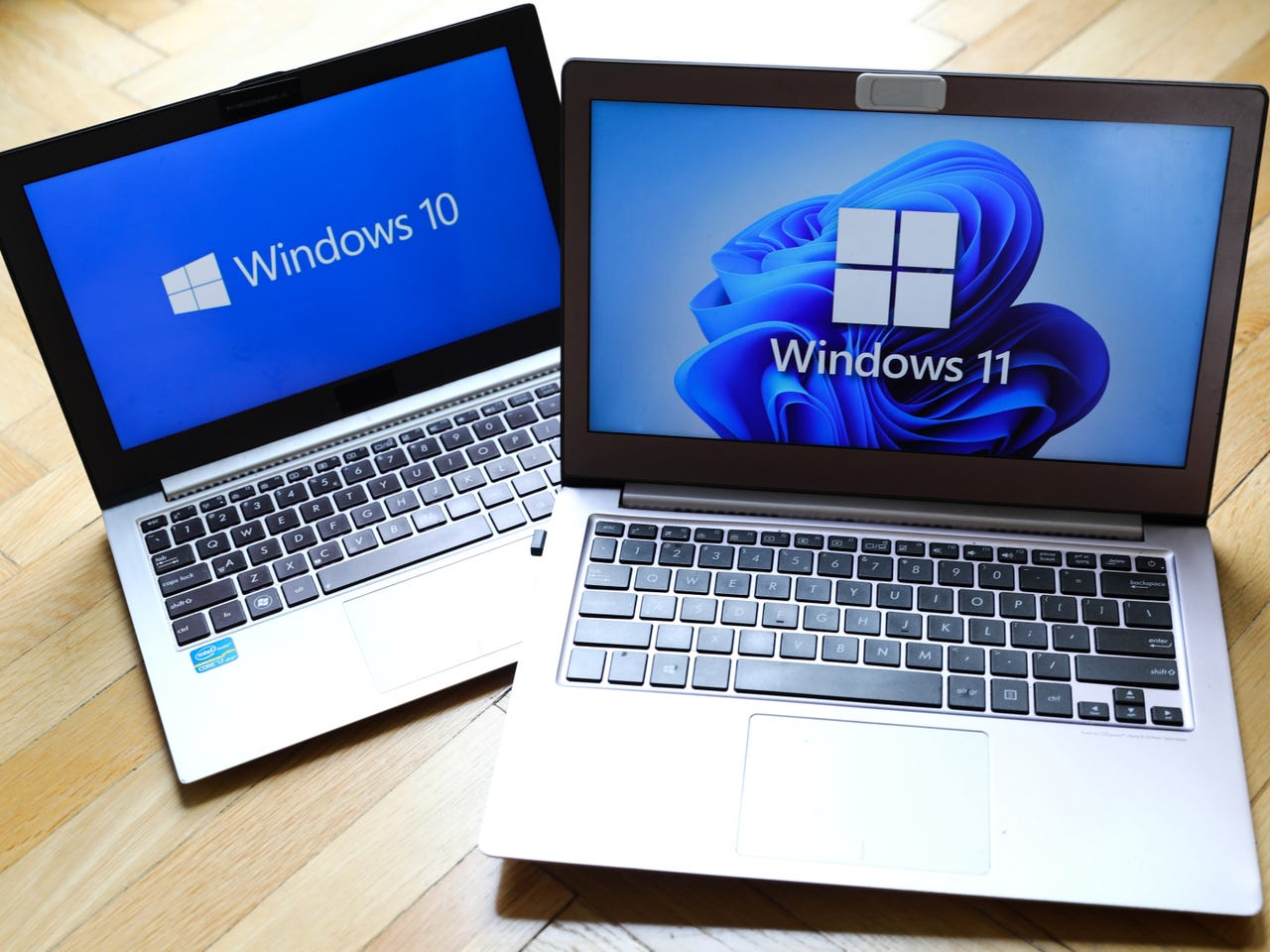 Windows 10 and Windows 11 logos on laptops
