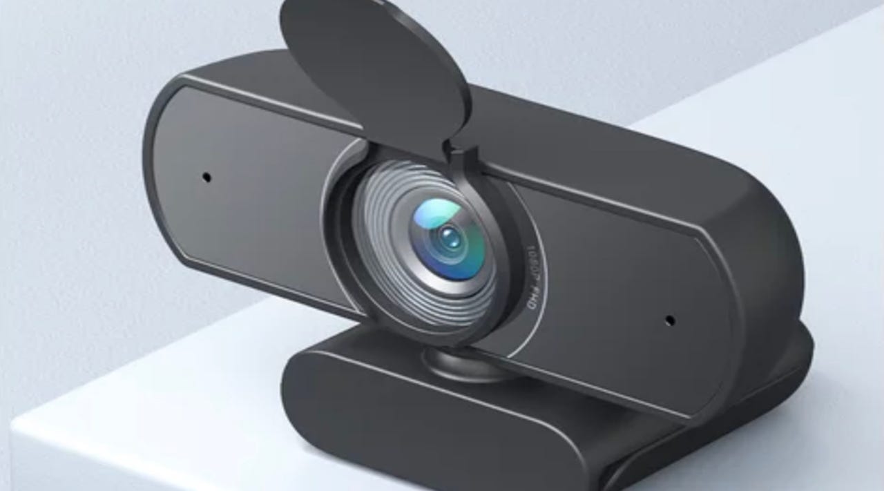 A black webcam with an open lens against a light grey background